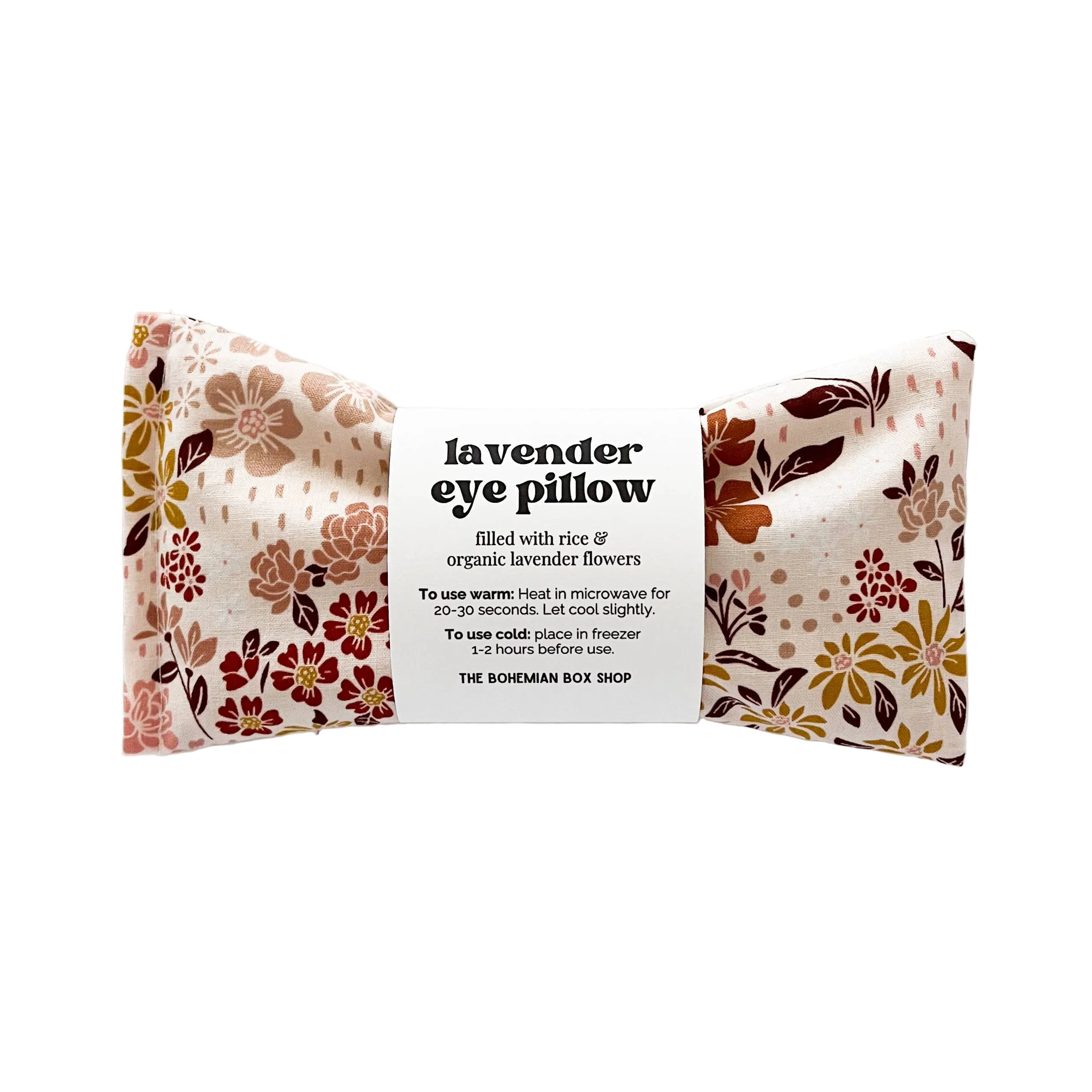 Floral-patterned lavender eye pillow with label on a light gray background